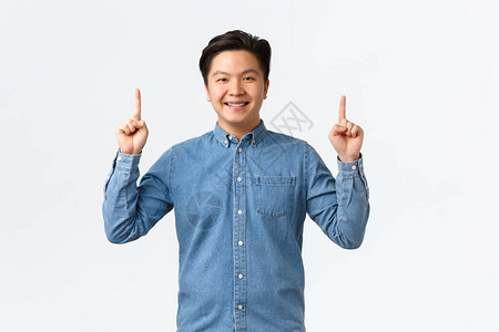 身穿蓝色衬衫的亚洲男模微笑着自豪而快乐地发布公告图片