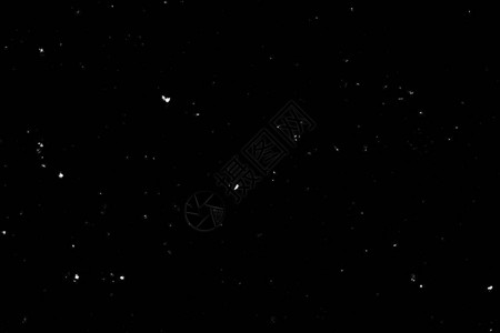 黑色背景上的白色散景光点纹理飘落的雪花星空背景图片