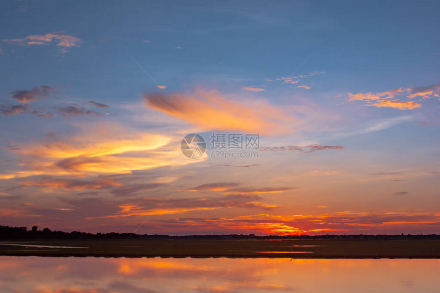 日落倒影泻湖在云层和蓝天之上的泻湖景观背景之上的美丽日落日落时有云图片