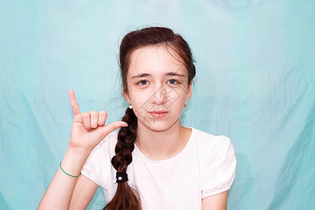 一个留着长辫子的女孩用手聋哑人的手语展示字母Y中等计划图片