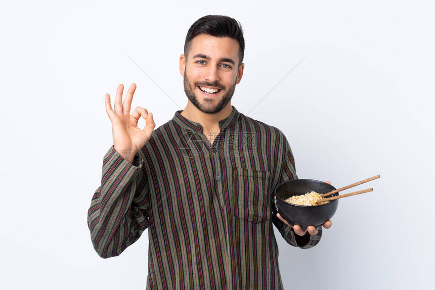 身处孤立背景的年轻人在拿着一碗面条和筷子时图片