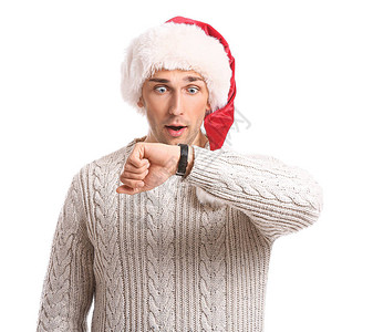 圣诞老人帽子和手表的惊奇的年轻人在白色圣诞图片