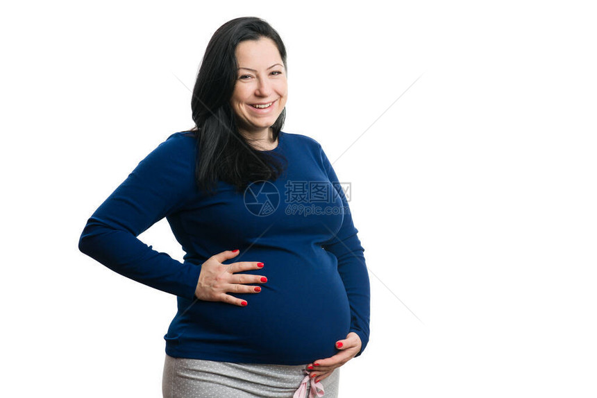 妇女笑着在怀孕肚子上握手图片