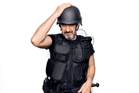 身穿警用防弹背心和安全头盔的中年英俊警察因犯错而感到惊讶图片
