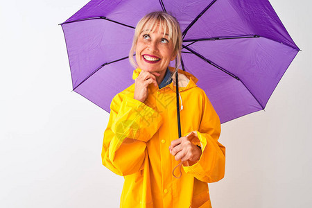 中年妇女穿着雨衣和紫色雨伞图片