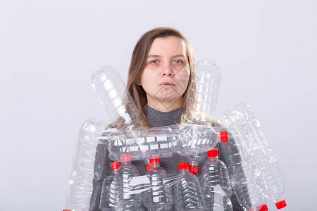 塑料污染问题与环境保护有塑料瓶的虚弱疲惫的女人拯救的概念清图片