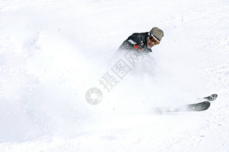 雪旋风中的滑雪者滑雪者在滑雪坡上转图片