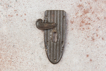 混凝土背景的古董黄铜键眼锁背景图片