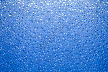 水滴蓝色背景玻璃背景上的水滴图片