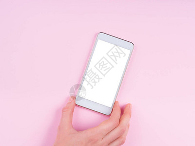 粉红抽象背景的白色空屏幕女手持移动电话粉红背景图片