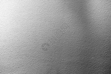 白色石膏墙纹理背景上的光束图片