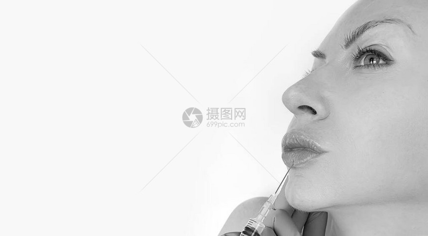 女人脸注射器嘴唇美容概念图片