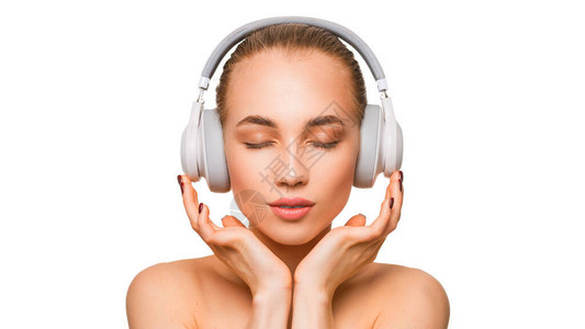 戴耳机的漂亮女人在听音乐时闭着眼图片