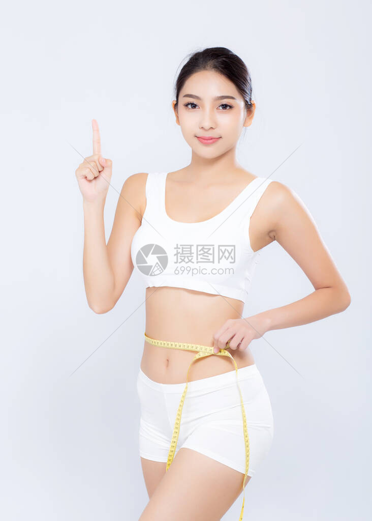 美丽的肖像亚洲女饮食和苗条的腰部测量体重手指向白色背景上孤立的东西图片