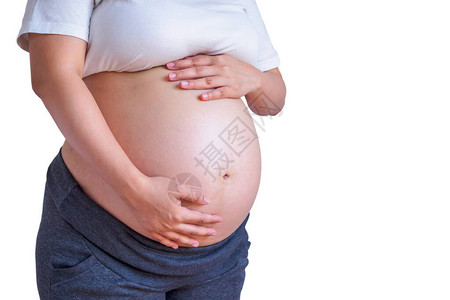 孕妇触摸她的腹部隔离在白色背景图片