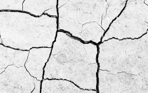 白色干燥和破裂的地面球背景干燥裂隙地面特写地球纹理上的灰图片