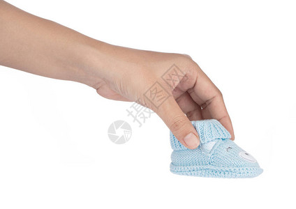 手握着蓝色婴儿鞋白图片