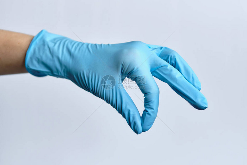 一只手拿着医疗手套抽象地握着图片