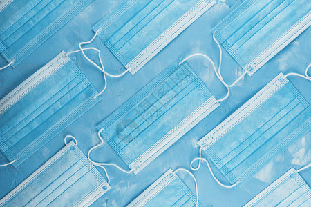保护免受冠状感染的蓝色背景的医疗面具流行病和保健概念模式平板图片