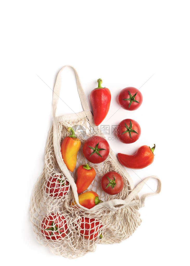 拒绝塑料生态购物袋中白色背景的有机红色蔬图片
