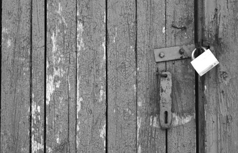 黑色和白色木制门上的旧锁背图片