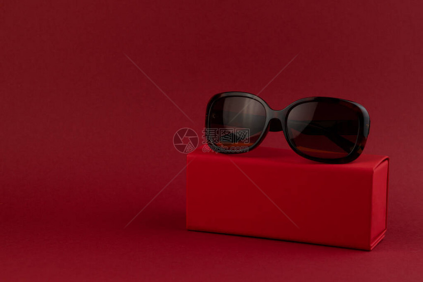 红色背景上的盒子上的时尚太阳镜极简风格极简主义时尚图片