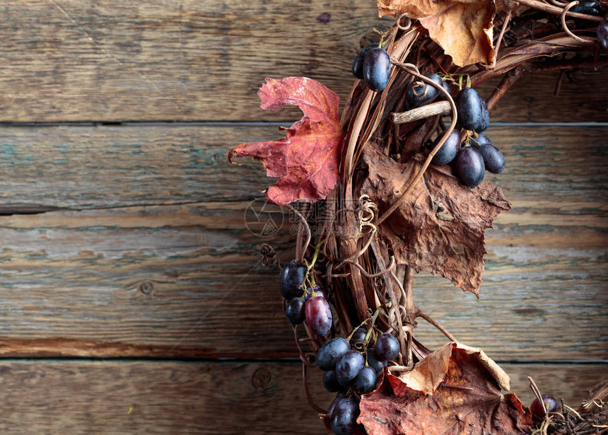 木制背景上的葡萄和干醋叶复制文本空图片