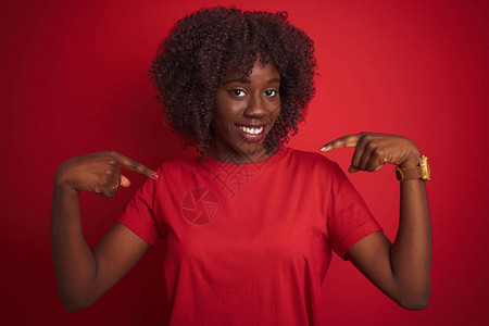 年轻的非洲黑人女穿着T恤站在孤立的红色背景上图片