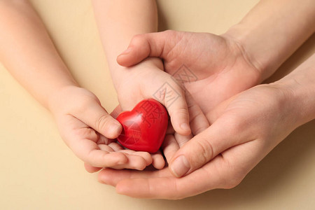 红心染色背景的妇幼之手心脏病图片