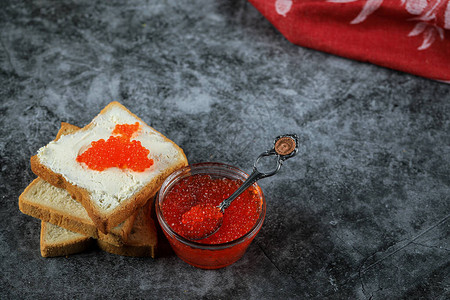 玻璃罐中的红鱼子酱和面包切片图片