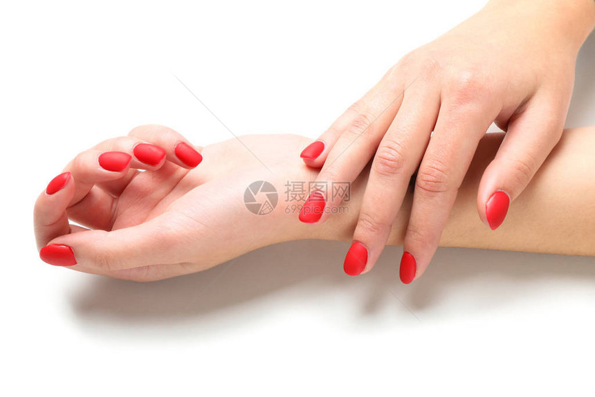 女手时尚的红指甲在白色背景上隔图片