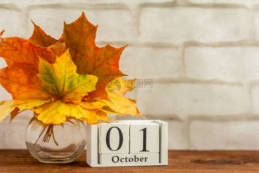 10月1日在木制日历上和一束枫叶的秋天秋季月份的日期图片
