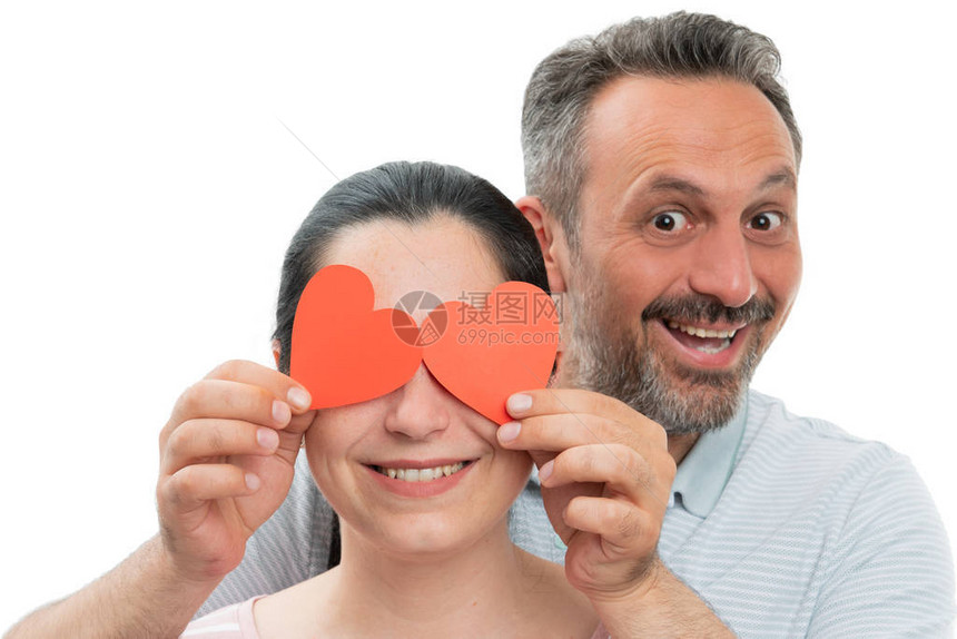满心欢喜的男子在女人眼中拿着红纸心像爱的概念孤立图片