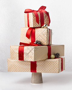 贴近手工制作的礼物盒在圣诞树和白图片