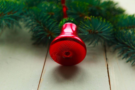 木制上的圣诞树枝和复古红色铃铛图片