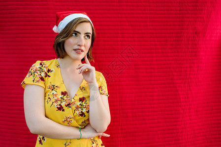 有圣诞帽子和黄色礼服的年轻女孩红色图片