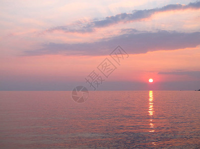海岸上风景如画的柔和的粉红色日落图片