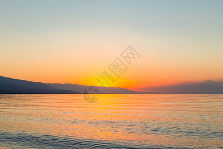 海上太阳的黎明山后初升的太阳图片