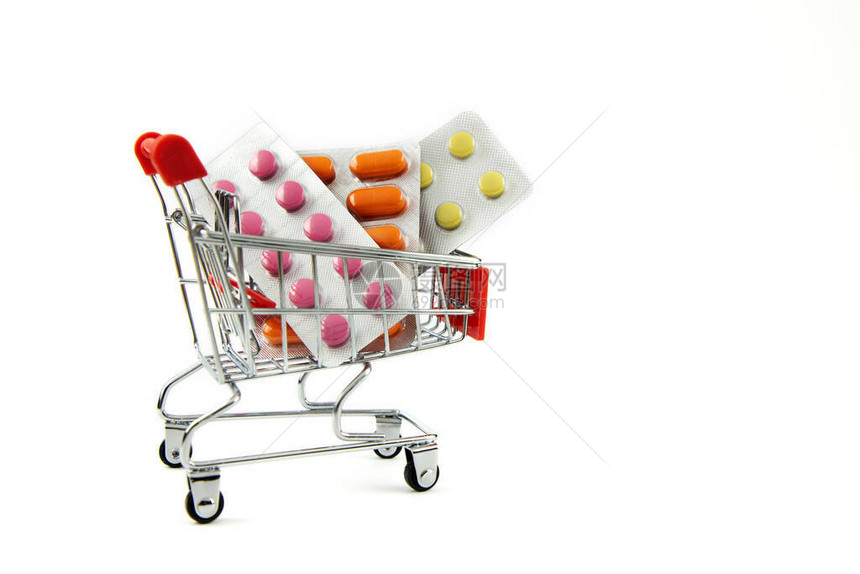 医学概念白色背景上的购物车中的各种药丸药丸和胶囊买药购买和销售药片和药片图片