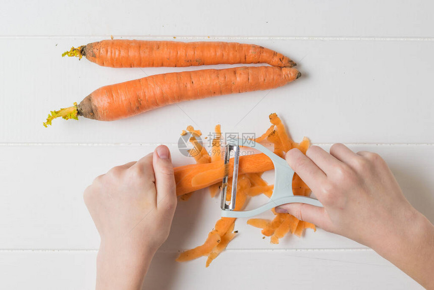 一个孩子的手用一把特殊的刀来削蔬菜用一把特殊的图片