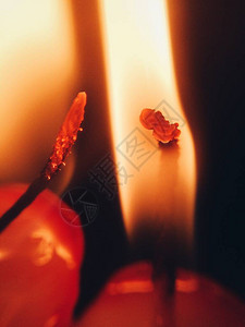 点燃热火的蜡烛在模糊的黑色图片