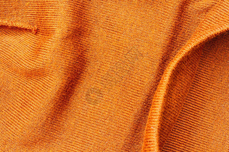 用聚酯和丙烯酸织物材料制成的褶皱亮砖橙色现代时尚和时尚帽子质地的特写图片