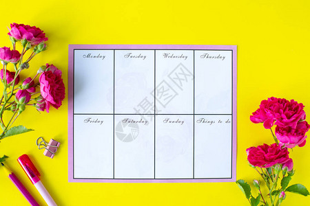 黄色背景的笔记和待办事宜列表粉红色文具和花图片