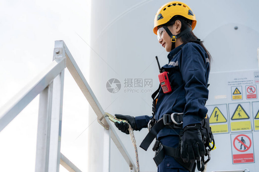 泰国风电场安全风力涡轮机的亚洲女检验工程师穿着安全带和安全线工作准图片