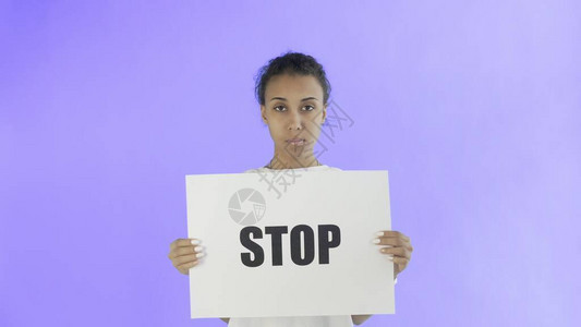 在紫色背景上张贴禁止海报的非裔美洲女孩活动图片