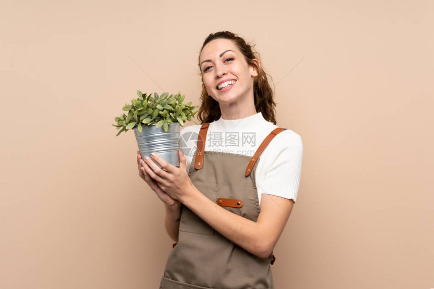 拿着植物的园丁妇女图片