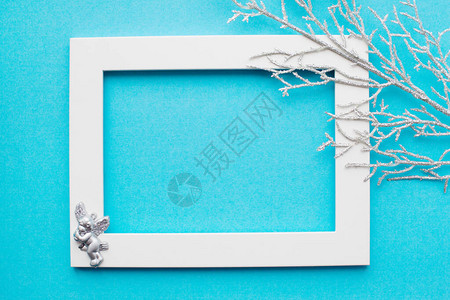 白色框架银色分支和蓝色背景上的天使新年节日装饰有文本的地图片