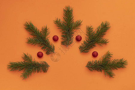 用于圣诞节和新年贺卡的创意组合五根青松枝和四颗红色装饰圣诞球形背景图片
