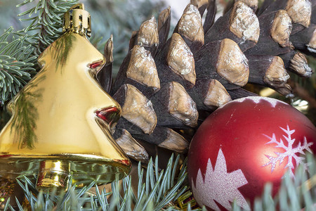 使用绿色松枝松果金色装饰圣诞树和红色装饰球制作的圣诞和新年贺图片