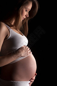 黑暗背景下孕妇的图片